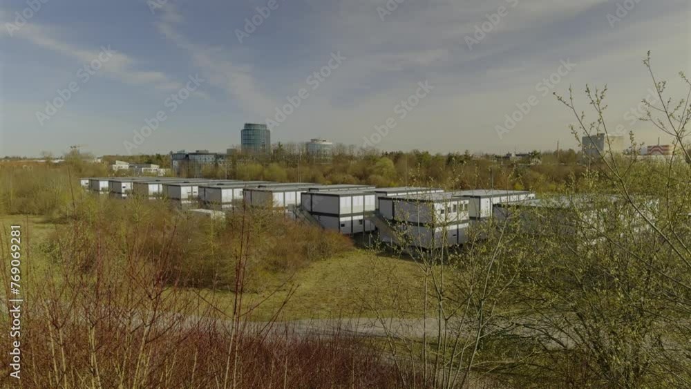 Migrant camp for refugees from Ukraine in Munich, Germany. Temporary shelter for war asylum seekers in germany. Container houses for immigrants in Europe. Temporary container city for refugees. Migrant camp for refugees from Ukraine in Munich, Germany. Temporary shelter for war asylum seekers in germany. Container houses for immigrants in Europe. Temporary container city for refugees.