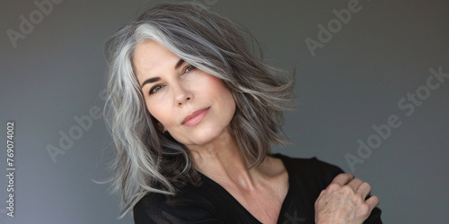 mature woman with grey hair over grey background photo