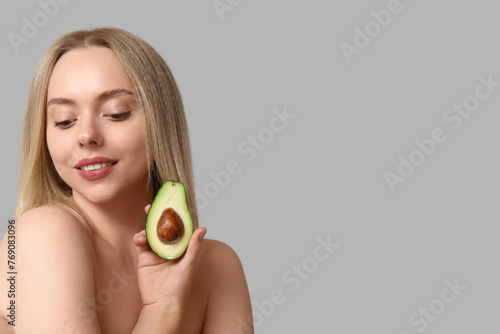 Young woman holding half an...