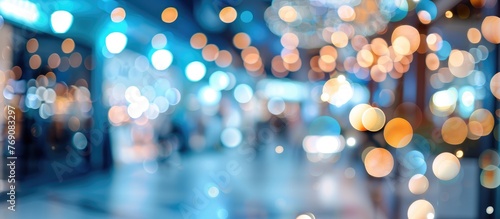 Colorful bokeh lights in a blurred environment with blue and white defocused interior.