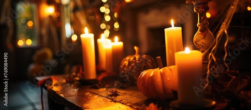 Close-up of Halloween-themed table with lit candles in a dimly lit room
