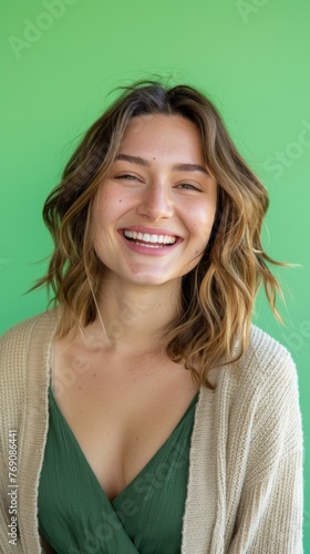 A woman in a green dress and tan cardigan smiles happily. Green sreen background. Generative AI photo