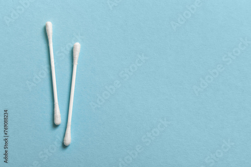 Ear sticks with cotton buds on blue background