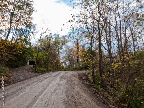 Captivating Autumn View in Quaint Ancaster Village, Hamilton, Ontario: Peaceful Rural Road Winds Through Stunning Fall Foliage, Embracing the Beauty of the Season with Gentle Motion Blur.