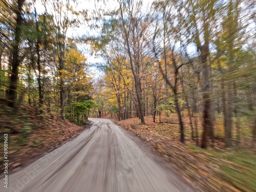 Idyllic Fall Scene of Ancaster Village, Hamilton, Ontario: Scenic Gravel Pathway Meanders Amidst Rich Autumn Hues, Enveloping the Essence of Nature's Grace with Soft Motion Blur.