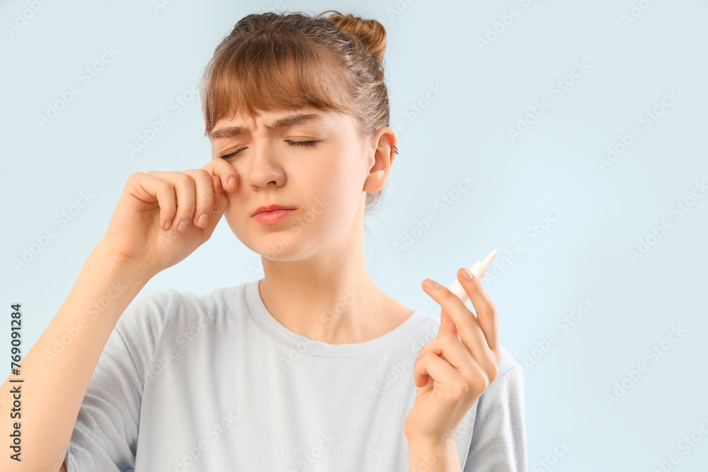 Young woman with eye drops on light background, closeup. Glaucoma awareness month Young woman with eye drops on light background, closeup. Glaucoma awareness month