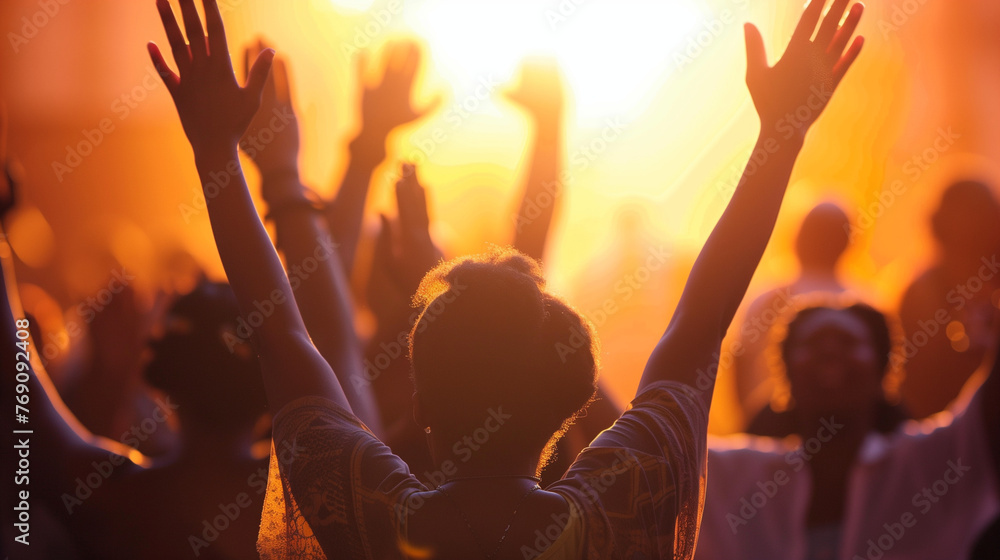 A group of worshippers with arms raised in praise and worship A group of worshippers with arms raised in praise and worship
