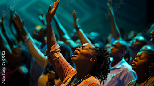 A group of worshippers with arms raised in praise and worship, expressing devotion and gratitude to God