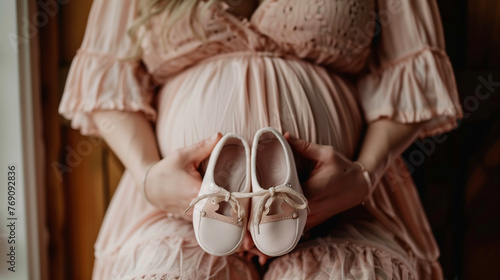 Wallpaper Mural Expectant Mother Holding Pair of Baby Shoes Torontodigital.ca