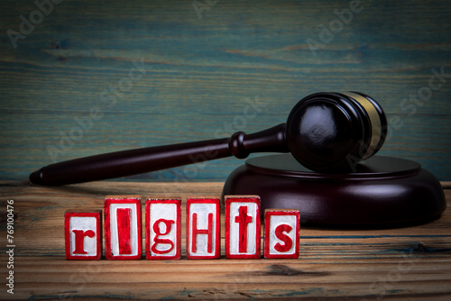RIGHTS. Red alphabet letters and judge's gavel on wooden background. Laws and justice concept
