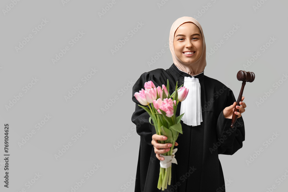Muslim female judge with pink tulips on white background. Women's Day celebration Muslim female judge with pink tulips on white background. Women's Day celebration