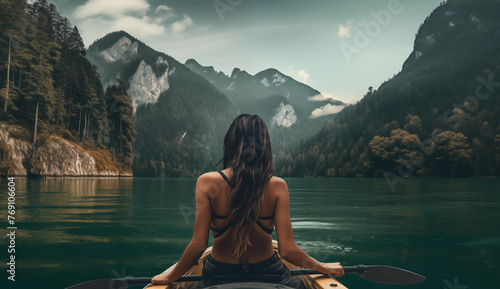 woman sitting on the edge of a lake