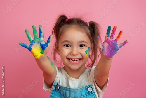 Child showing hands painted in colorful paints