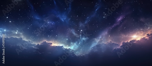 Dark night sky adorned with twinkling stars and wispy clouds creates a serene celestial view