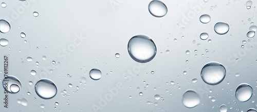 Focused on a cluster of small water droplets condensed on a clear window pane