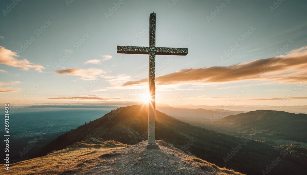 cross on top of a mountain at sunset - obrazy, fototapety, plakaty 
