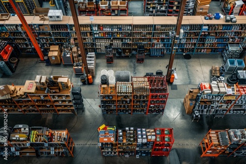 A birds eye view of a large warehouse filled with numerous shelves holding auto parts in a well-organized manner