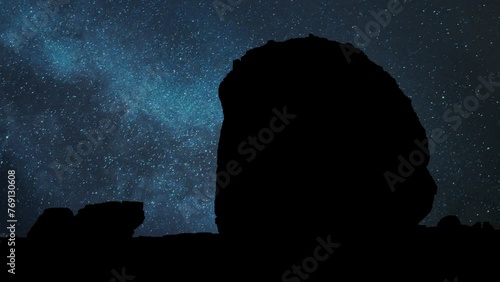 Tomb of Lihyan, son of Kuza carved in rock in the desert, Time Lapse by Night with Stars and Milky Way in Background, Hegra, Saudi Arabia photo