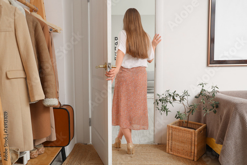 Young woman walking away th...