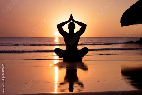 Silhouette of a man practicing yoga on the beach at sunset. Healthy lifestyle concept, poster, banner, copy space.