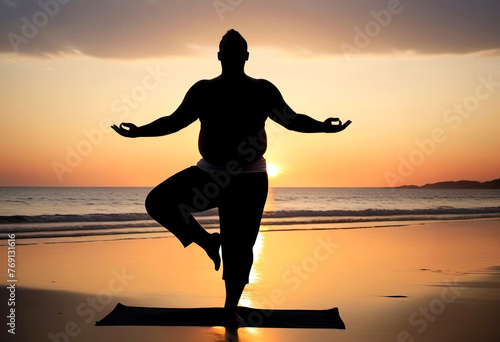 Silhouette of a overweight man practicing yoga on the beach at sunset. Healthy lifestyle concept  poster  banner  copy space.