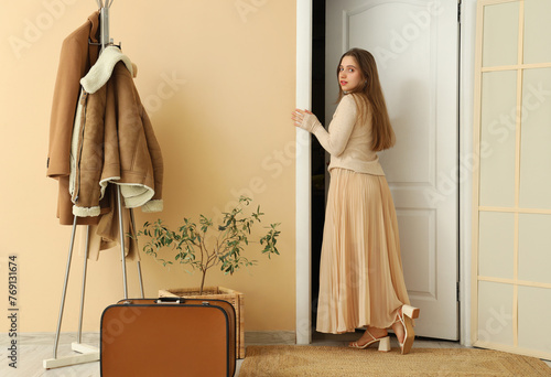 Young woman walking away th...