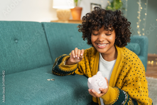 Saving money investment for future. African American girl holding pink piggy bank and putting money coin. Saving investment budget business wealth retirement financial money banking concept