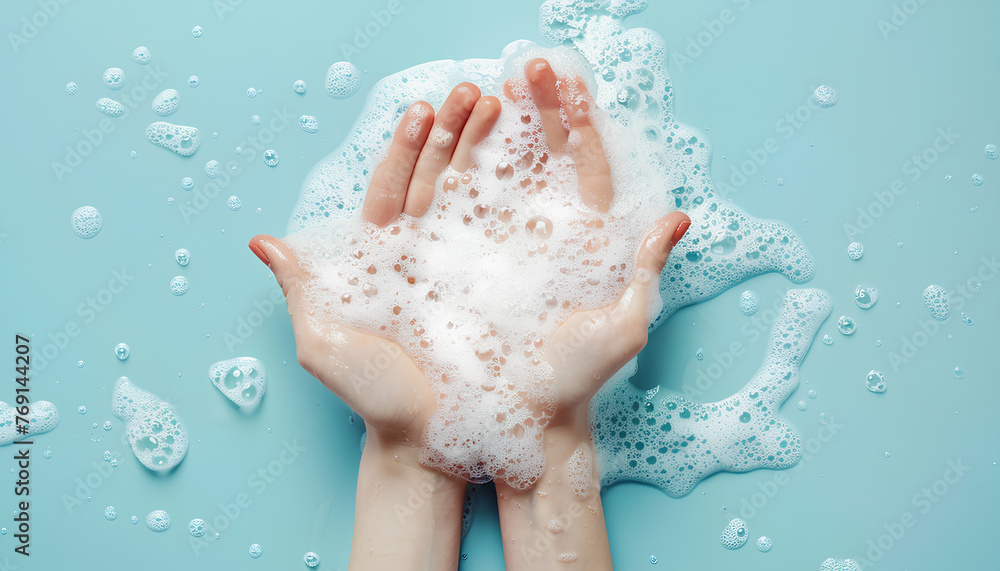 Hands in soap foam on light blue background Hands in soap foam on light blue background