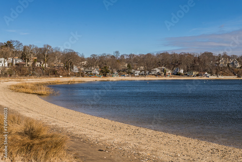 Homes aligned shoreline and sandy beach