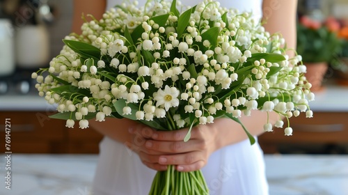 a close up of a person holding a bouquet of flowers in front of a counter with a counter top in the background. photo