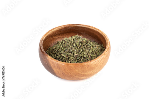 Dried thyme leaves in a bowl on white background. © svdolgov
