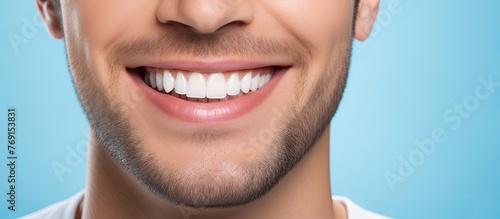 A man with a big smile on his face is brushing his teeth with a toothbrush in his mouth photo