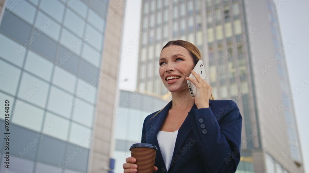 Beautiful lady boss call walking urban street with coffee closeup. Woman talking