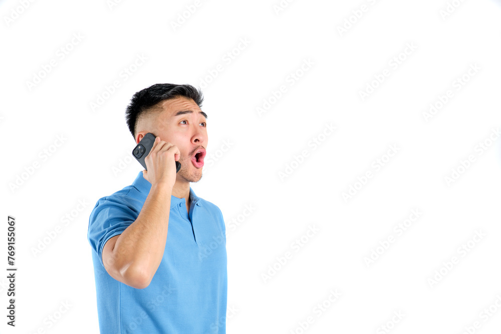 young oriental man with surprised face talking on his smart phone on white background young oriental man with surprised face talking on his smart phone on white background
