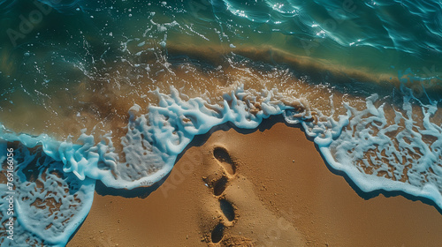 A beach with a pair of footprints in the sand
