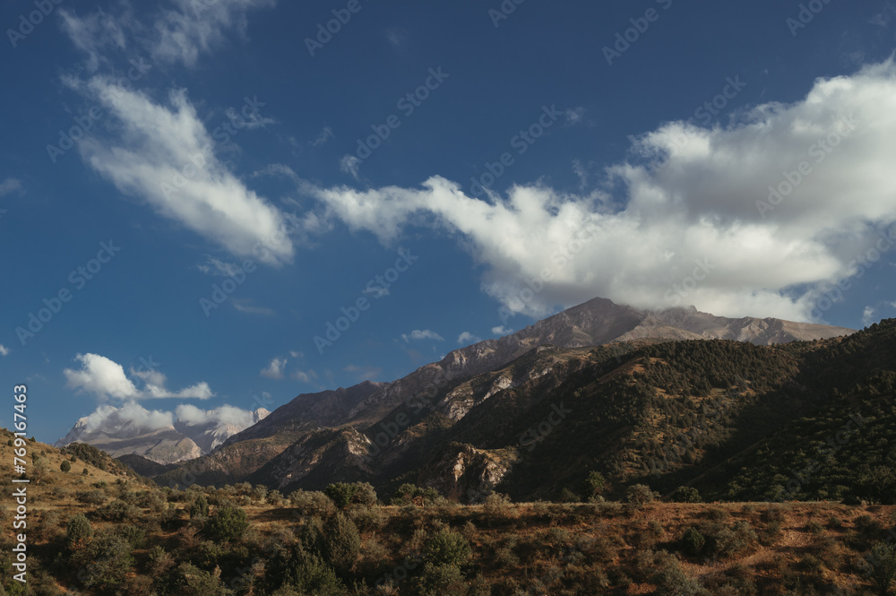 landscape with mountain peaks background the sky with clouds at sunset in a summer landscape with mountain peaks background the sky with clouds at sunset in a summer