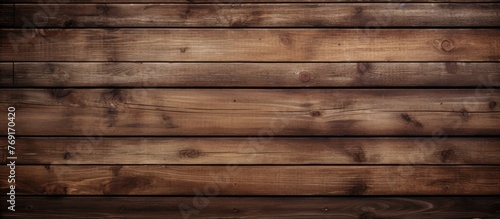 A closeup shot showcasing the beauty of a brown hardwood plank wall, with intricate patterns and tints and shades of wood stain, making it a stunning building material for flooring