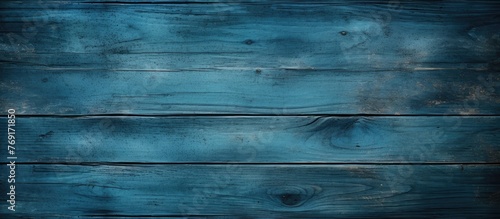 A textured blue wood background with a rough and uneven surface, perfect for rustic or industrial design projects