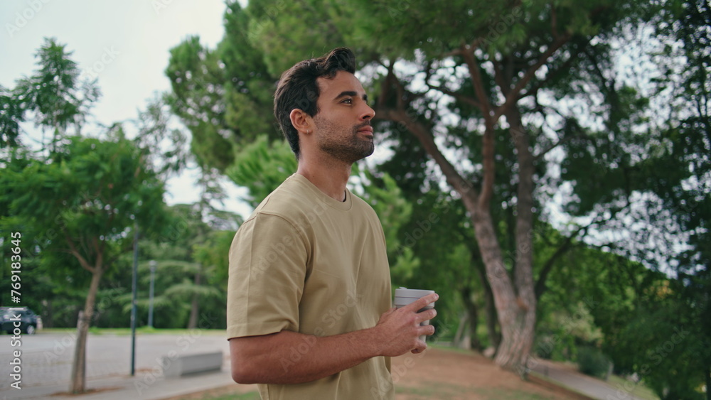 Stylish man standing park holding beverage takeaway closeup. Relaxed italian guy