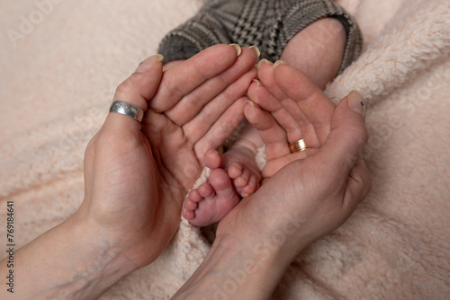 feet newborn baby in a white cloth in my mother's hands	