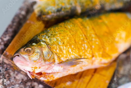 Preparation of bocachico fish with turmeric seasoning for lunch, seafood meal photo