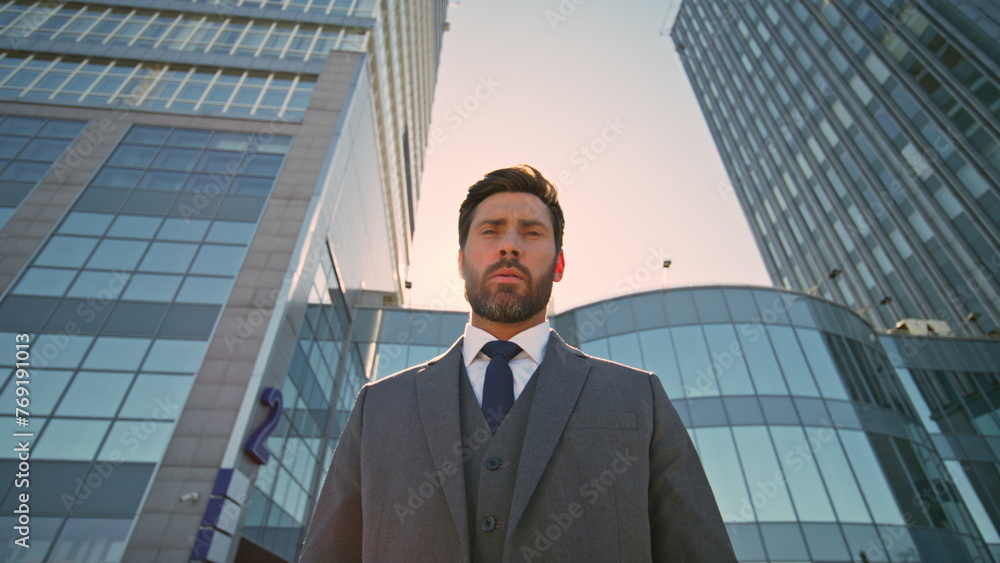 Rich director posing downtown at evening sunlight close up. Serious businessman Rich director posing downtown at evening sunlight close up. Serious businessman