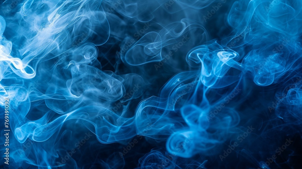Obraz premium Ethereal beauty of blue smoke swirling through cold air.