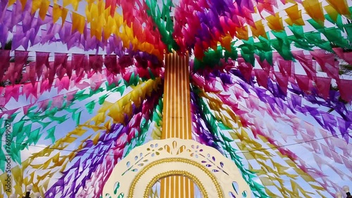 andor de madeira ornamentado com imagem de são joão e bandeiras coloridas de festa junina no nordeste brasileiro photo