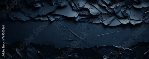 torn navy blue papper on a black background  photo