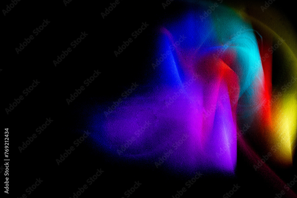 Abstract rainbow on textured black background. Long exposure. Light painting photography.