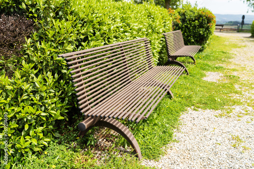 Wooden bench at pubic park in summer season with nice design in Italy