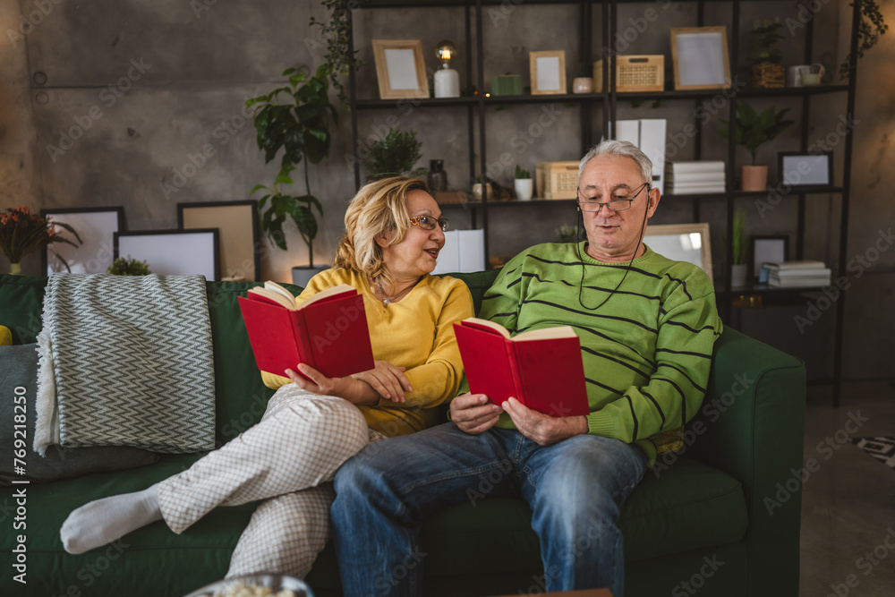 mature senior couple man and woman husband and wife read book at home mature senior couple man and woman husband and wife read book at home