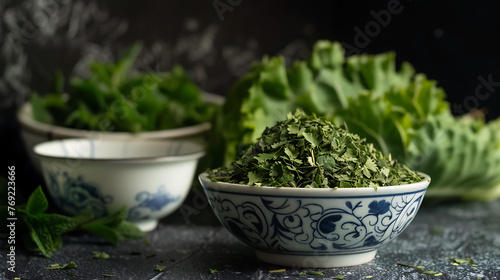 a small bowl of dried, crumbled green herbs in the foreground.