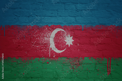 colorful painted big national flag of azerbaijan on a massive brick wall